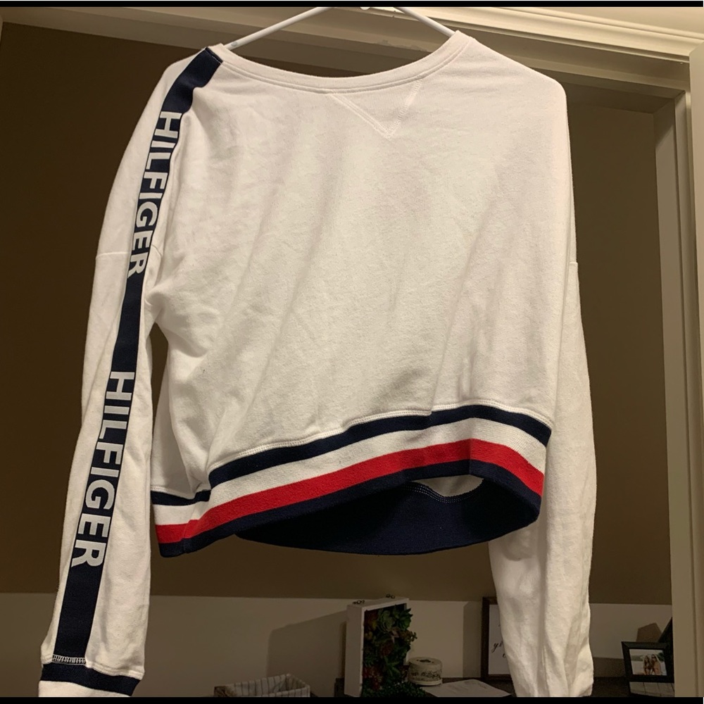 This is a white blue and red Tommy brand sweater